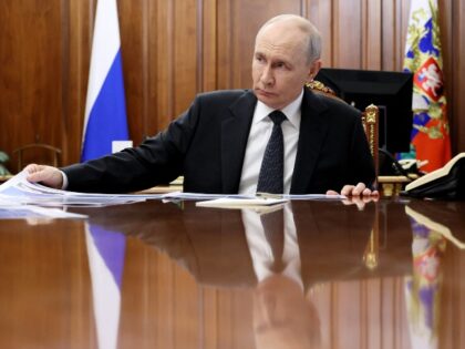 In this pool photograph distributed by the Russian state agency Sputnik, Russia's Pre