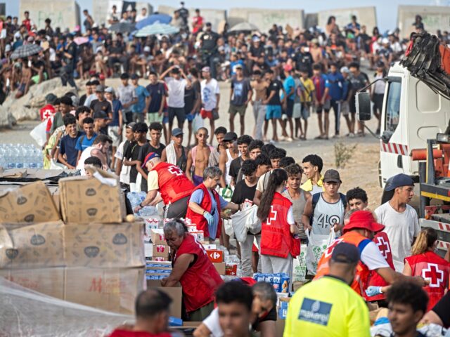red cross Ceuta CEUTA, SPAIN - SEPTEMBER 07: The Red Cross is distributing food on El Trampolin beach, on