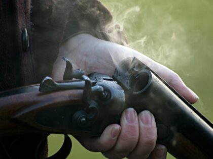A Toledo, Ohio, woman used a shotgun Tuesday morning to hold two men at bay for police aft
