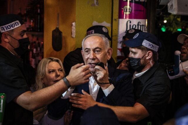 Israeli Prime Minister Benjamin Netanyahu speaks in Ben Yehuda Market during a campaign vi