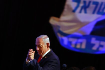 Israel's Prime Minister Benjamin Netanyahu gestures to his supporters at an election