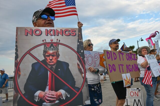 Protesters hold signs and flags during the 'No Kings' national day of protest in