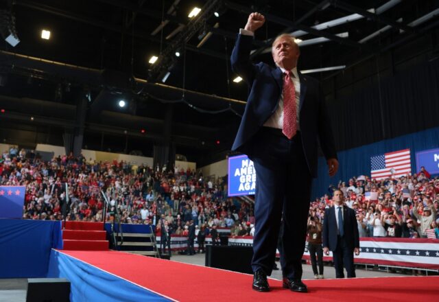 US President Donald Trump greets supporters at an October 2026 rally in Kansas -- a state