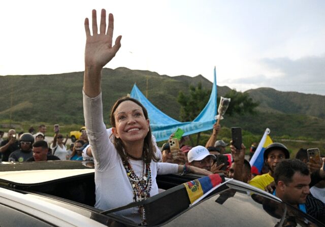 Venezuelan opposition leader and Nobel Peace Prize laureate Maria Corina Machado greets su