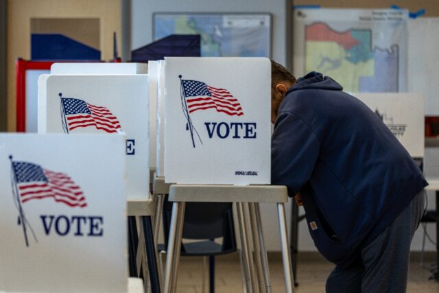 A voter fills out his midterm ballot at the Douglas County Clerk Election Office in Lawren
