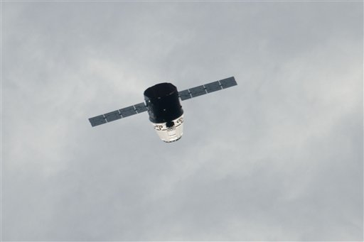 Private supply ship flies by space station in test
