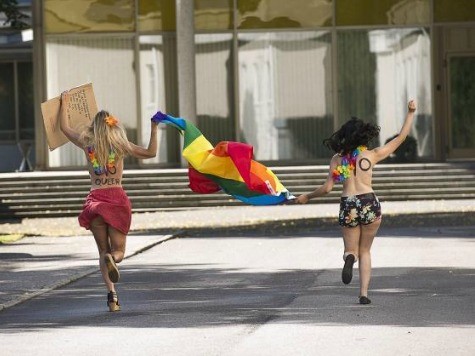 Bare-Breasted Femen Protesters Besiege Bishop in Spain