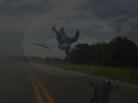 Watch: Motorcyclist Slams into Trailer, Files Off Bike