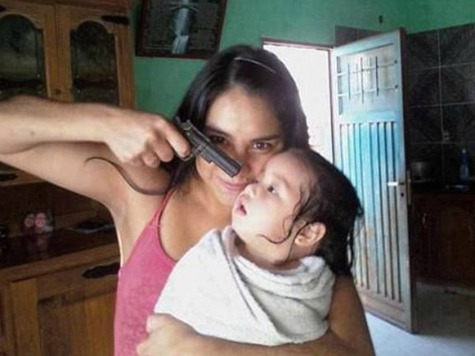 Photo of Woman Pointing Gun at Toddler's Head Sparks International Search