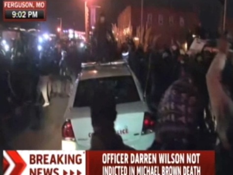 Watch: Rioters Attack Police Car in Ferguson