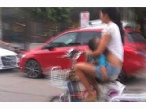 Woman Pulled Over For Breastfeeding on Moped